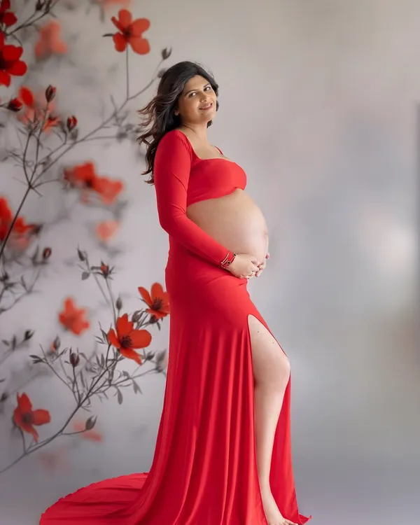 A bold and beautiful portrait in red. This gown from my studio wardrobe, with its thigh-high slit and bare-bump design, is perfect for moms who want to celebrate their changing body.
