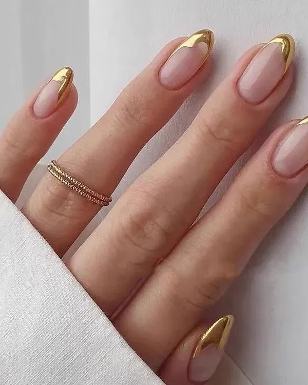 A flawless set of almond-shaped acrylic extensions featuring a modern French manicure with stunning gold chrome tips. This look is the ultimate statement in sophisticated glamour, perfect for any special occasion or when you just want to feel royal.