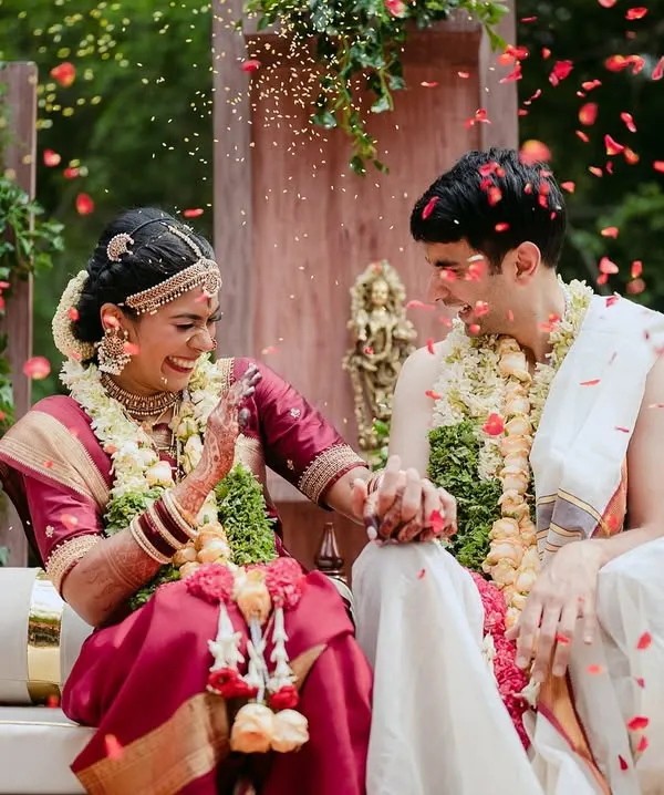 A joyful moment as a couple is showered with petals during their South Indian wedding ceremony. Our venue is a canvas for such beautiful, candid moments.