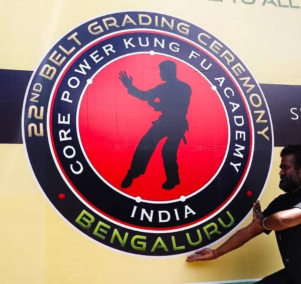 Posing in front of the banner for our 22nd Belt Grading Ceremony in Bengaluru. These events are a major milestone for our academy and our students.