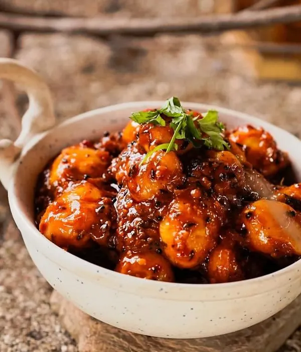 My Tamarind Potatoes are a perfect balance of sweet and tangy. Baby potatoes are cooked in a thick, flavorful tamarind sauce and garnished with fresh cilantro.