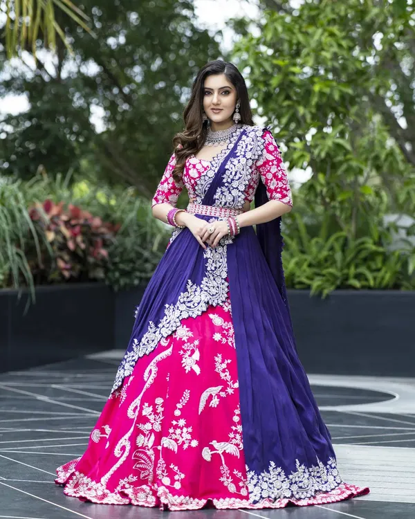 This ensemble showcases my passion for 3D embroidery and bold color blocking. The pink and blue lehenga features a sculpted skirt and a blouse detailed with intricate corded cut dana work, creating a striking, modern bridal look.