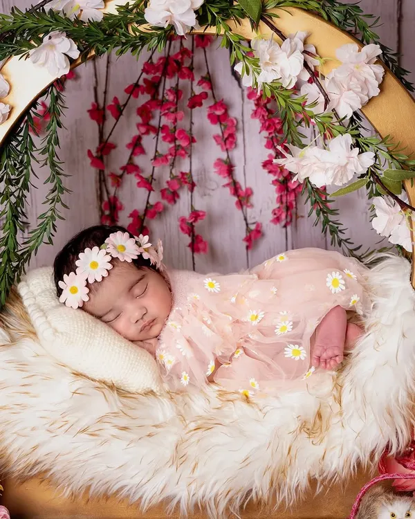 This is the magic I strive to create. A peacefully sleeping newborn, nestled in a bed of soft fur and flowers, dreaming her first dreams. Every detail is arranged with love to capture their pure innocence.