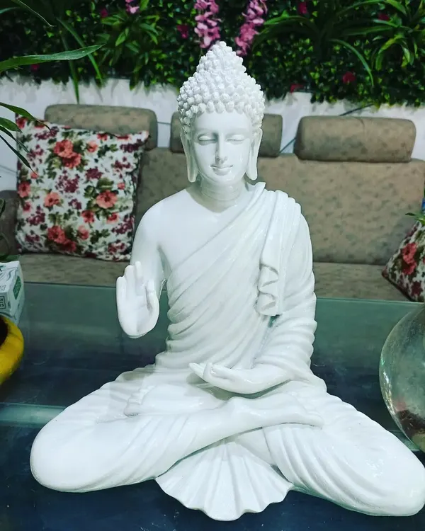 This medium-sized white marble Buddha statue is available for purchase. It's perfect for adding a touch of serenity to your home or garden.