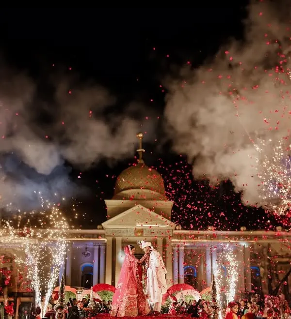 A fairytale moment captured as fireworks light up the sky over a palace wedding. We specialize in creating these grand, unforgettable images that define a celebration.