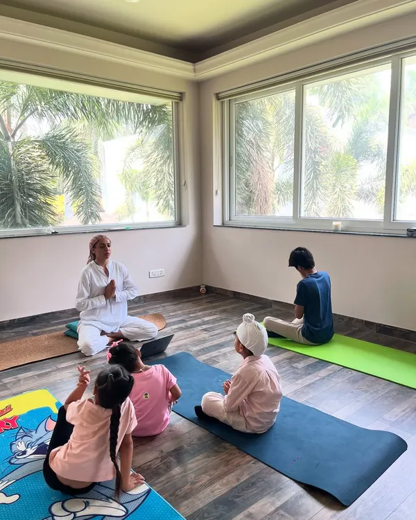I love this moment of connection and play during a kids' yoga class. While I guide the session, children are free to explore movements in their own way, fostering a positive relationship with their bodies.