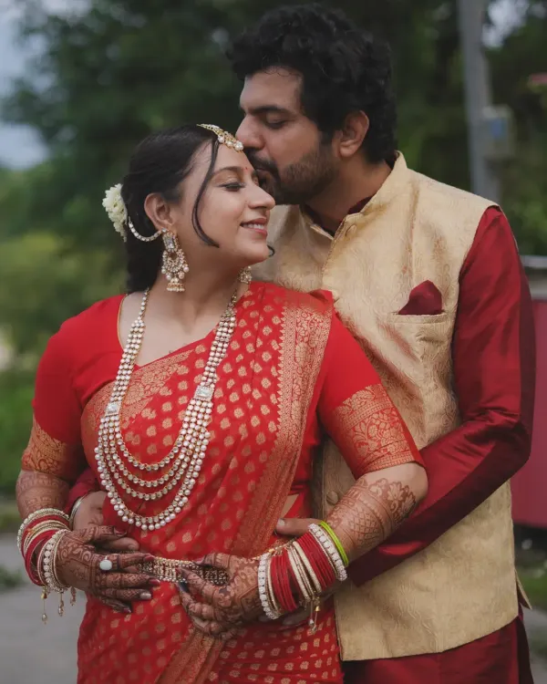 A tender moment of affection during a destination pre-wedding shoot. The misty mountains provide a serene backdrop for this intimate portrait, highlighting the couple's quiet connection.