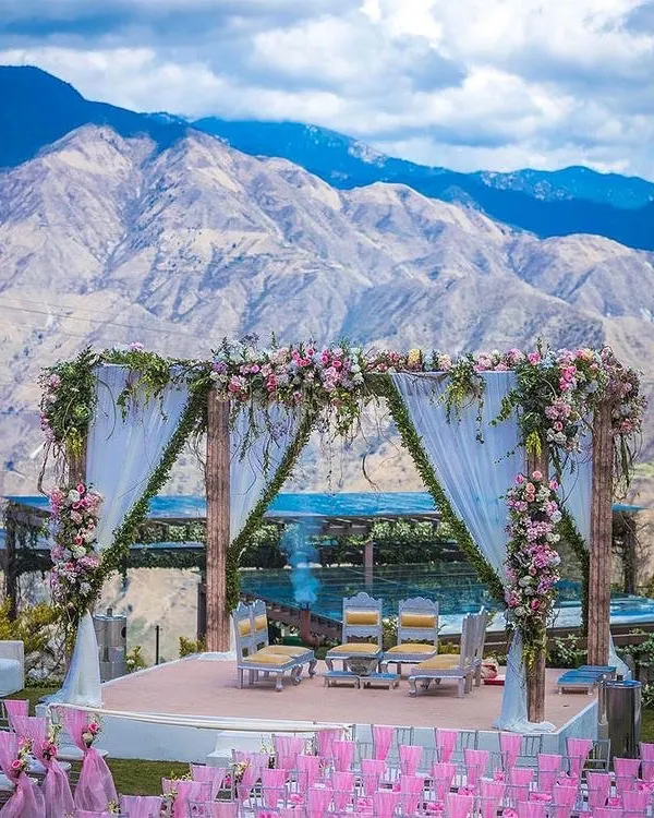 A spectacular wedding mandap set against a majestic mountain range. We specialize in creating these harmonious blends of natural beauty and elegant design for destination weddings.