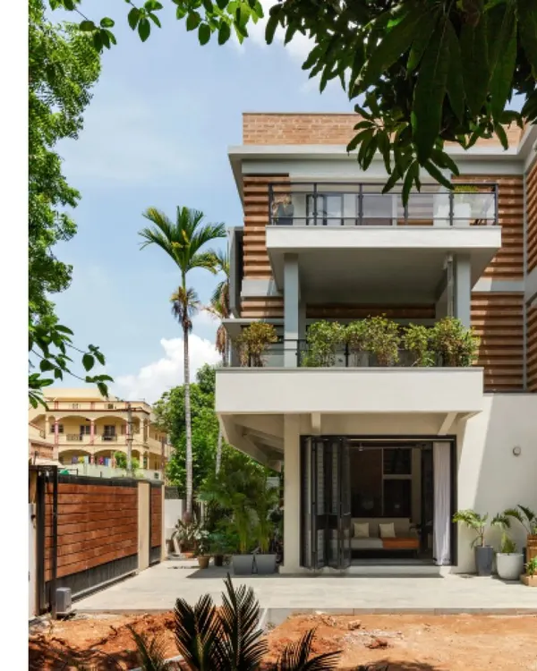 The renovated and extended residence for Sunith and Shruti in Hyderabad. The new facade features a striated pattern of alternating brick courses, a design choice that was both an aesthetic decision and a practical solution to material shortages during the pandemic.
