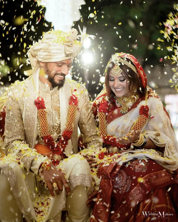 The moment of pure joy and celebration, showered in petals. This candid shot of Urjaa and Tejas captures the happiness of finally being married, surrounded by love and laughter.