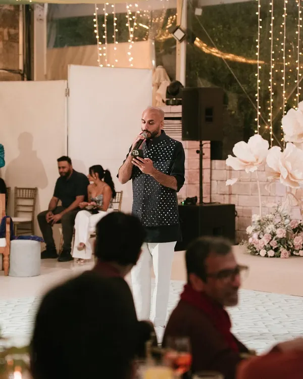 On the mic during a Sangeet night in Lisbon. Hosting and engaging with the crowd is a huge part of what I do. It's about creating a fun, interactive atmosphere for everyone.
