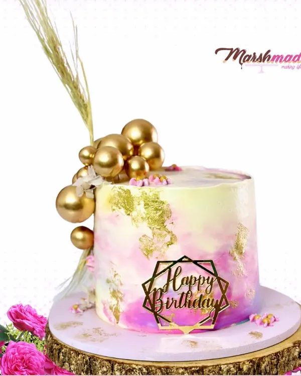 Tall cakes are so popular right now, and I love creating them. For this chic cake, I used a watercolour technique with buttercream and added gold leaf and gold spheres for a touch of glamour.