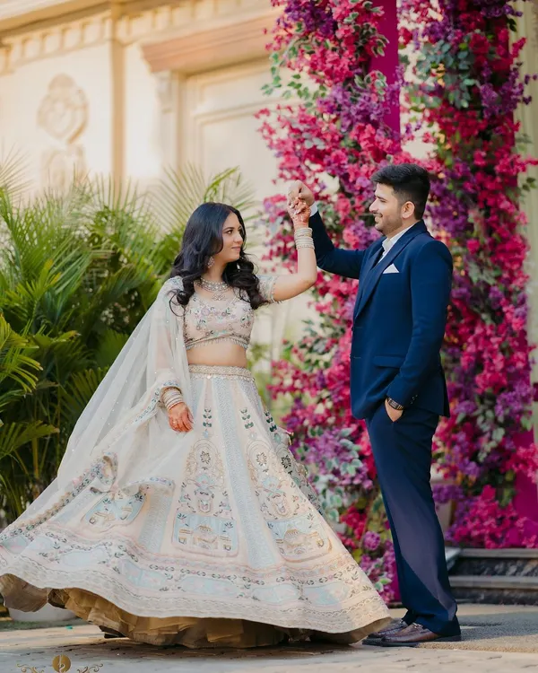 A fairytale moment from a ring ceremony, as the couple shares a dance against a stunning wall of pink and purple flowers. This is a perfect shot for a grand and beautiful engagement.