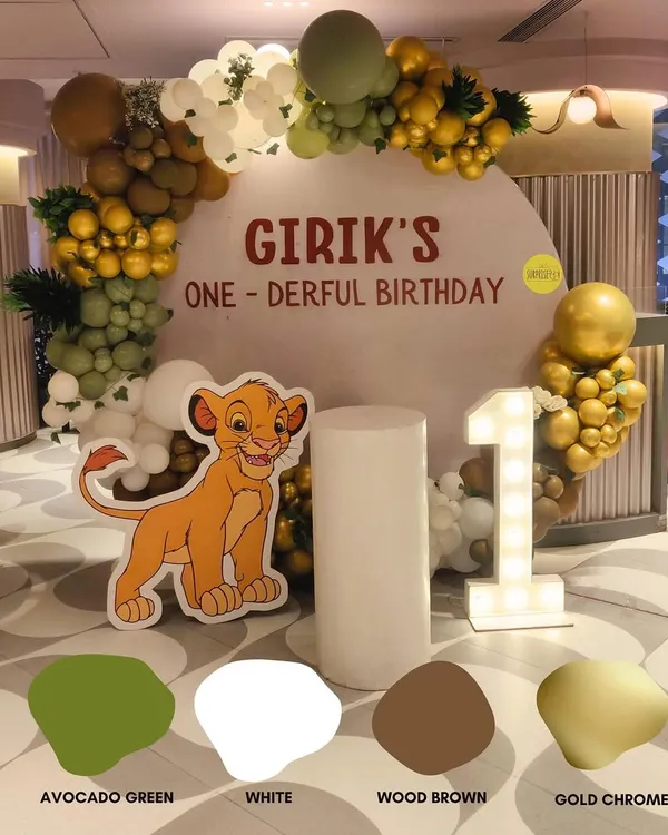 For Girik's "one-derful" first birthday, I chose a sophisticated jungle theme palette of avocado green, wood brown, and gold chrome. The result was an elegant yet playful Lion King adventure.