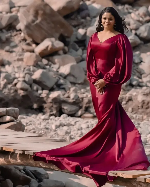 A full-length view of the custom-made magenta fishtail dress. You can really see the dramatic silhouette here, with the gown fitting snugly through the body before flaring out into a long, sweeping train. This is one of my most requested cocktail dress designs.