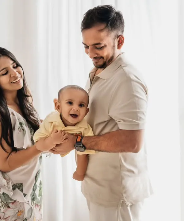 A beautiful, bright family portrait against a simple white backdrop. This minimalist style allows the family's joy and connection to be the main focus.