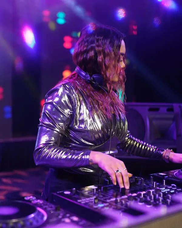 A focused shot of me at the decks, surrounded by colorful lights. This is my office.
