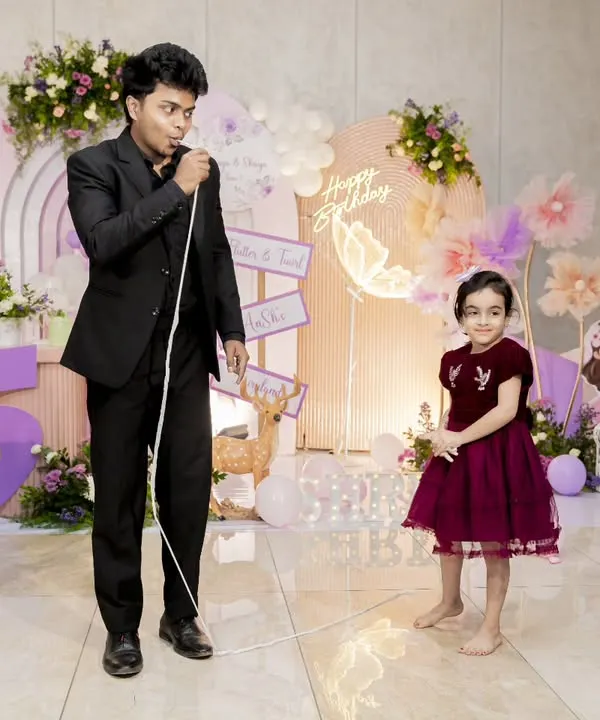 Here I am with the birthday girl at her 5th birthday celebration. I always make a special effort to interact with the guest of honor, making their big day even more magical.