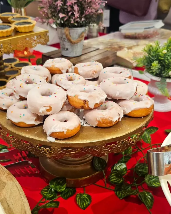 A golden stand adorned with my sugar-glazed mini donuts. These soft, sweet treats are a delightful addition to any dessert table and a favorite among all age groups.