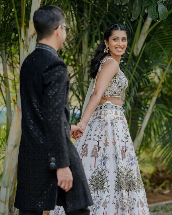 A candid moment from a cocktail celebration. The bride's joyful glance back at her partner captures the happiness of the occasion, with our venue's trees providing a natural frame.