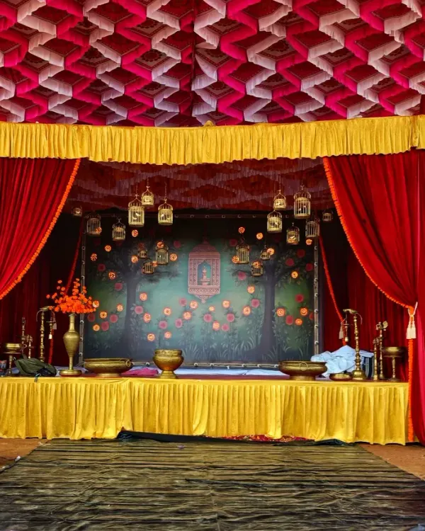 This is a classic stage design with a theatrical feel, using heavy red curtains and a decorative backdrop. The setup is ideal for cultural programs, award ceremonies, or traditional performances that require a formal and elegant setting.
