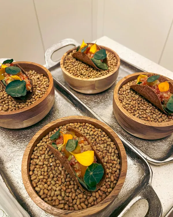 My canapé-sized mushroom tacos. These bite-sized treats are filled with fermented garlic aioli, green papaya som tam, and a truffle egg yolk gel.