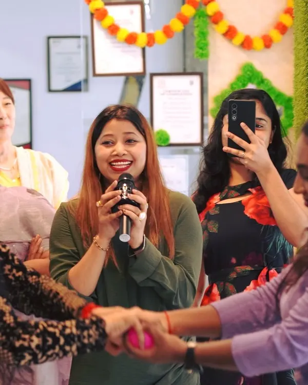 Our founder, Nazia Khanam, leads a fun activity during our Onam celebration. We foster an environment where everyone feels included and joyful.