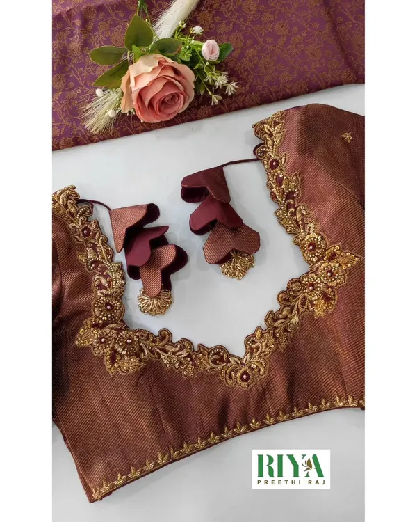 This blouse is all about unique details. I used a rich brown fabric and created an intricate neckline with Zardosi work. The standout feature is the custom tassels, made from layered, petal shaped fabric pieces that add a beautiful, three dimensional touch.