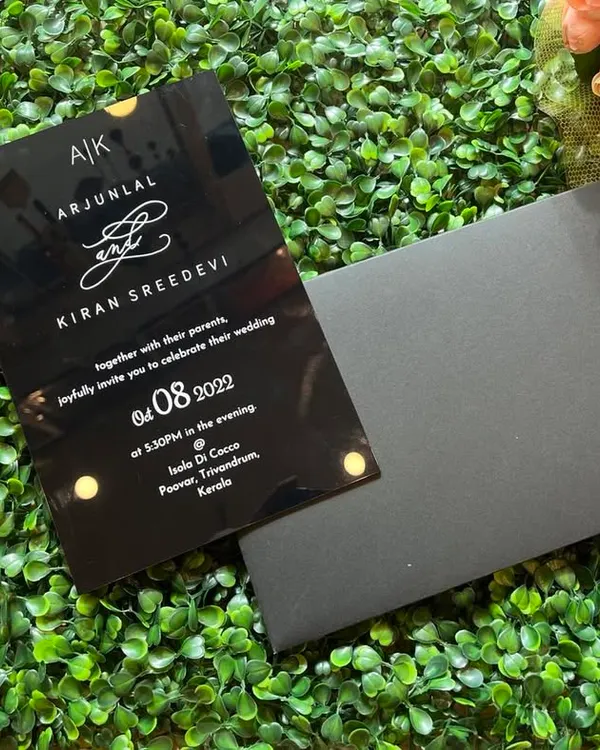 A bold and modern choice. This sleek black acrylic invitation features white screen-printed text and a custom monogram, paired with a matching black envelope.