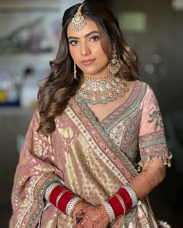 A quintessential bridal look featuring a simple twist, voluminous crown, and soft waves. This style is perfect for a classic and elegant bride on her wedding day.