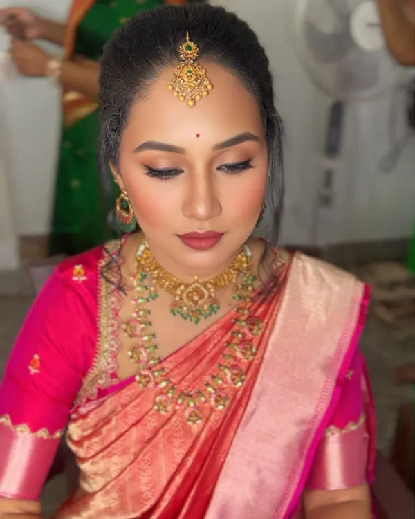 A beautiful soft glam look for a family event. This client is wearing a stunning pink and peach silk saree, and we paired it with a warm, neutral eye makeup, rosy cheeks, and a matte lipstick for an elegant finish.