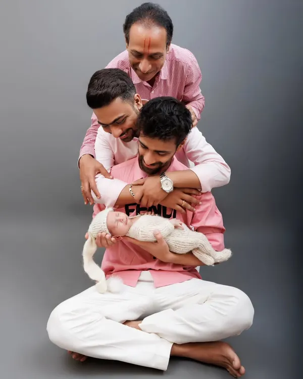 Three generations of love in one frame. This portrait of a baby with his father, uncle, and grandfather is a powerful tribute to family bonds. We shot this in the studio for a clean, timeless look.