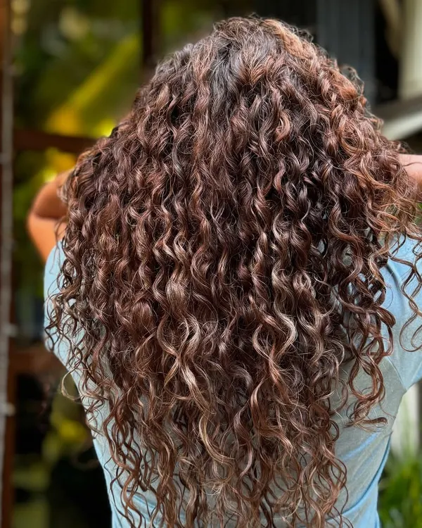 A stunning example of grey blending on long, beautiful curls. The highlights and natural greys work together seamlessly.