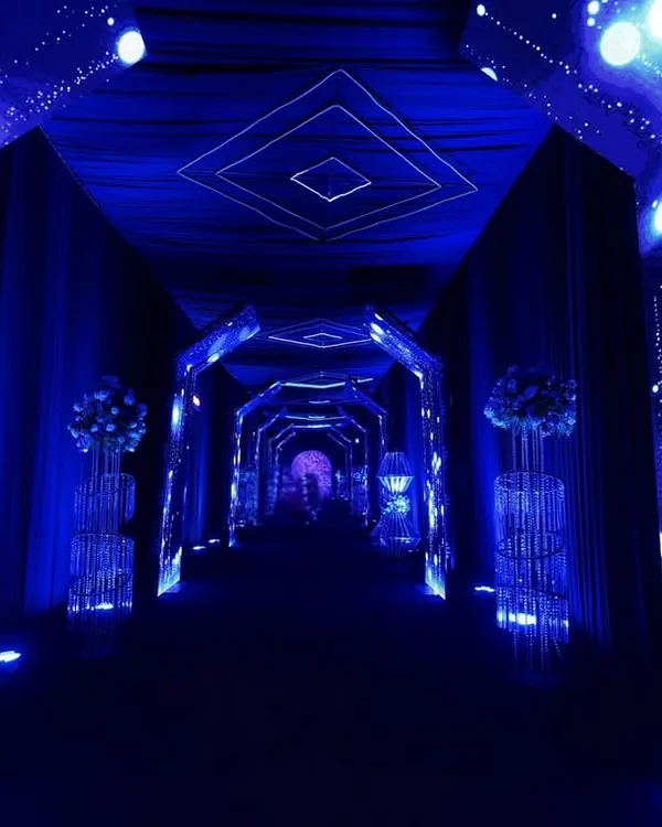 I designed this immersive tunnel entrance with dynamic LED walls and a geometric ceiling to feel like a portal to the party, setting a futuristic tone from the start.