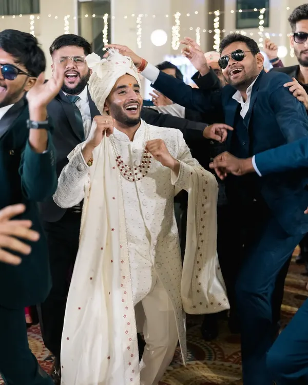 The groom's electrifying entrance to the Sangeet, surrounded by his best friends. We capture the energy and excitement of the dance floor.