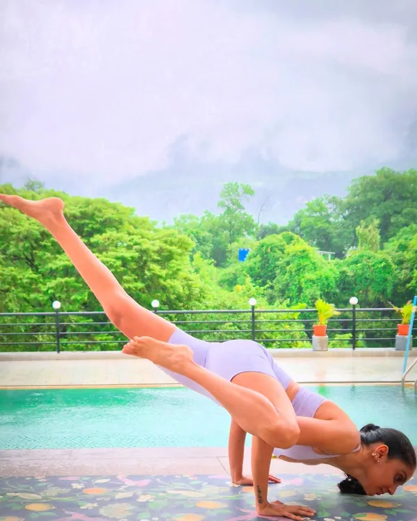 This is the feeling I aim for in my retreats: strength, balance, and complete serenity, with nothing but the mountains and the sky as our witness. Here I am finding my center with an arm balance by the pool during our Karjat retreat.