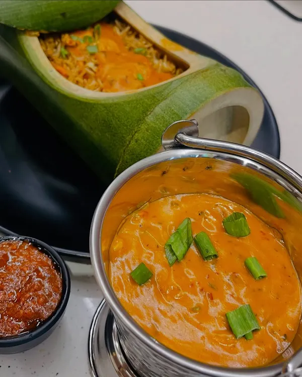 This is my showstopper dish, the Bamboo Rice. It features flavourful rice steamed inside a real bamboo shoot, served with a creamy gravy and a side of spicy schezwan chutney. It's a unique dining experience you won't forget.