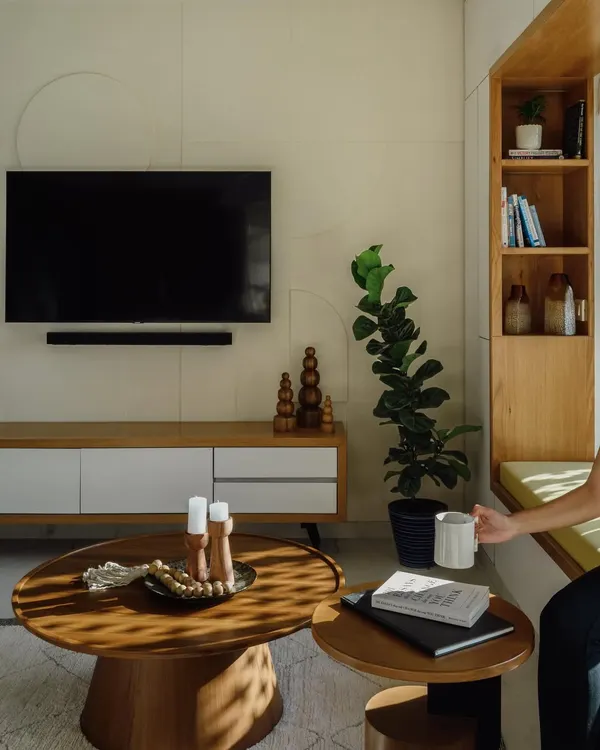 This living room features a set of nesting coffee tables I built. The solid wood tops and pedestal bases provide a modern yet organic feel. They are paired with a simple, low-profile TV console.
