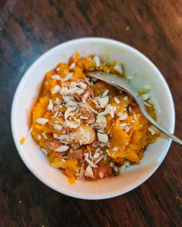 A meal isn't complete without dessert. Our piping hot Gajar ka Halwa, topped with sliced almonds, is the perfect way to finish your authentic North Indian feast.