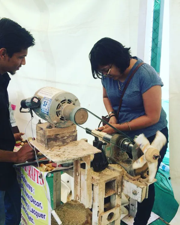 Here, one of our artisans provides one-on-one guidance to a visitor at the lathe. We ensure everyone feels comfortable and confident as they learn the basics of wood turning, making the experience accessible even for complete beginners.