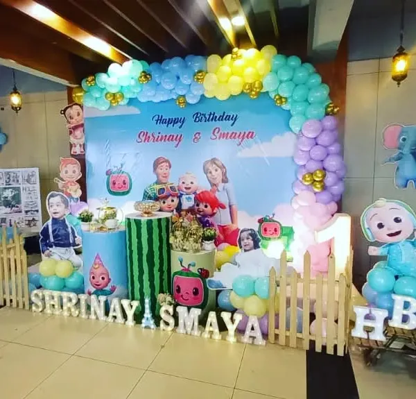 A colorful and fun Cocomelon theme for twins Shrinay and Samaya's first birthday. We created a vibrant backdrop with all their favorite characters, a balloon arch, and custom name signs for a picture-perfect celebration.