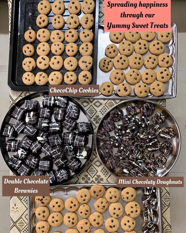 A beautiful spread of my homemade sweet treats. This includes classic ChocoChip Cookies, rich Double Chocolate Brownies, and fun Mini Chocolatey Doughnuts.