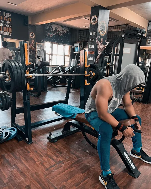 Discipline will take you to places motivation can't. This is a moment of rest and focus before the next heavy set on the bench press. The real battle is won in your mind before you even lift the weight.