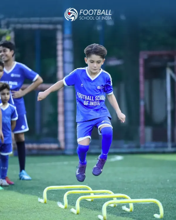 Agility and speed are crucial on the field. Here, a young athlete performs hurdle jumps, a key exercise in our training regimen designed to improve footwork, coordination, and explosive power for youth football players.
