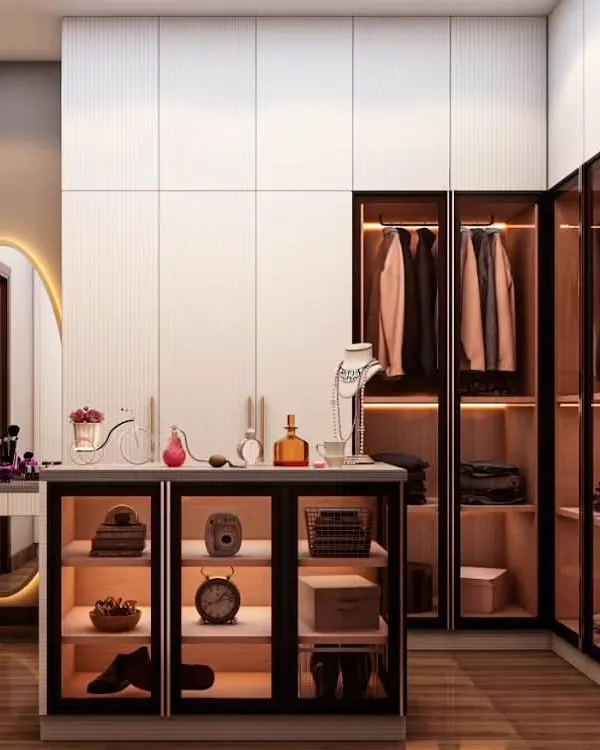 This walk-in closet combines open and closed storage for ultimate functionality. The design features glass-front drawers and cabinets with internal lighting, a dedicated vanity station, and ample hanging space.