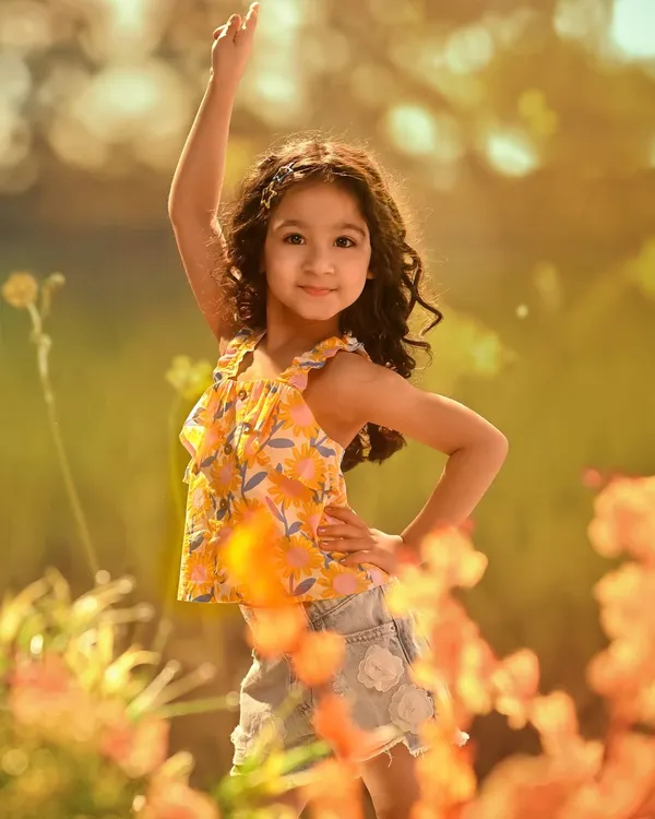 Capturing the pure joy and confidence of childhood. This shot, set against a projected background of a sun-drenched flower field, is full of life, color, and personality.