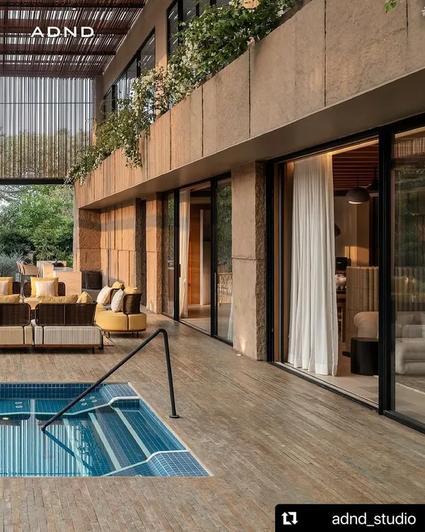 The poolside terrace at K House provides a seamless connection to the indoors. We used warm wood decking and planters with flowering bougainvillea to create a luxurious, resort-like atmosphere for lounging and swimming.