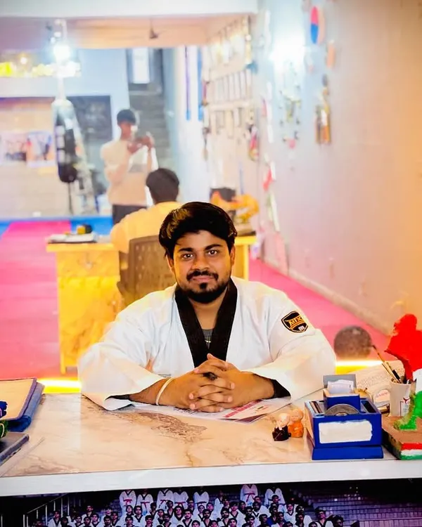 At my desk in the Aarav Taekwondo Academy. This is where I plan the training that will shape the future champions of India.