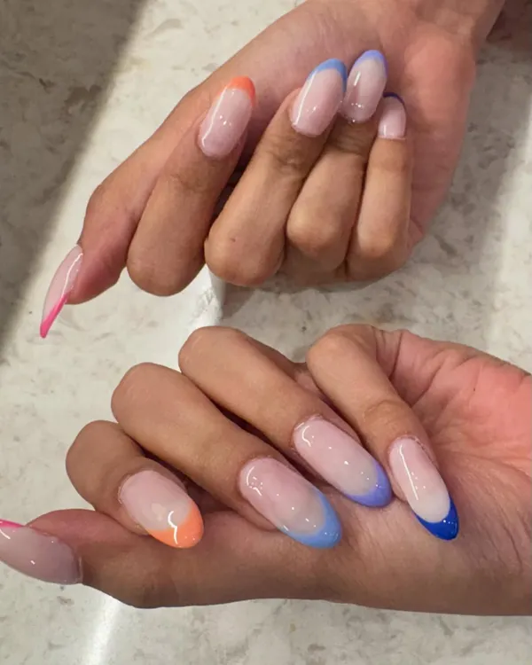 Why choose one color when you can have a rainbow? These trendy, colorful French tips on long almond nails are glossy, eye-catching, and so much fun.