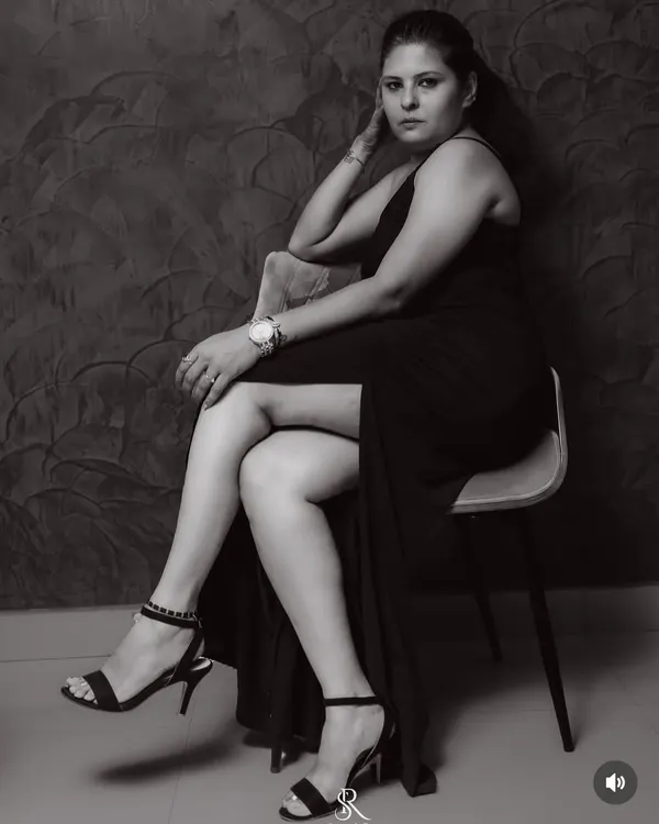 A dramatic black and white portrait in a classic black gown. This shot emphasizes the sleek lines and confident posture that the right dress can give you.